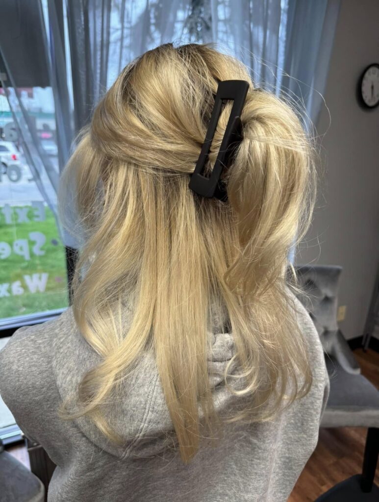 Blonde hair styled in a half-up twist