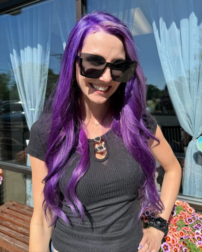 Purple hair with soft waves and a side part