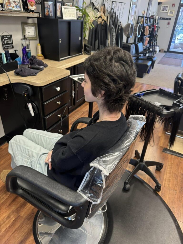 Short dark textured haircut at a styling station