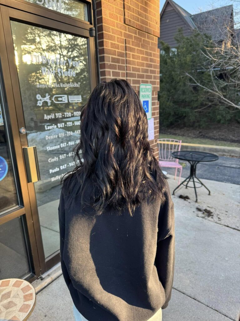 Long dark curls outside the Antioch studio